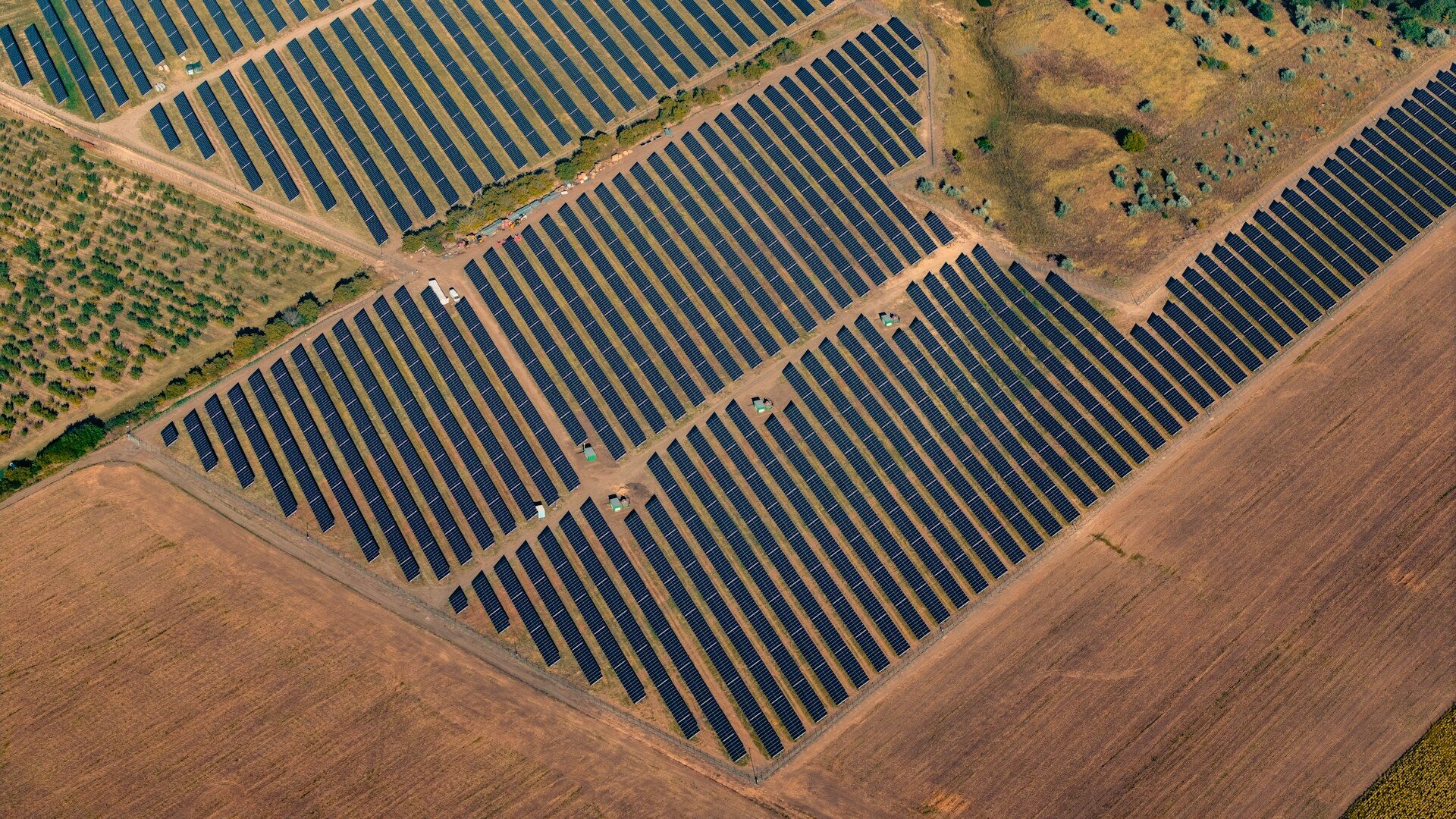 Aerial view of solar arrays in a dry agricultural landscape